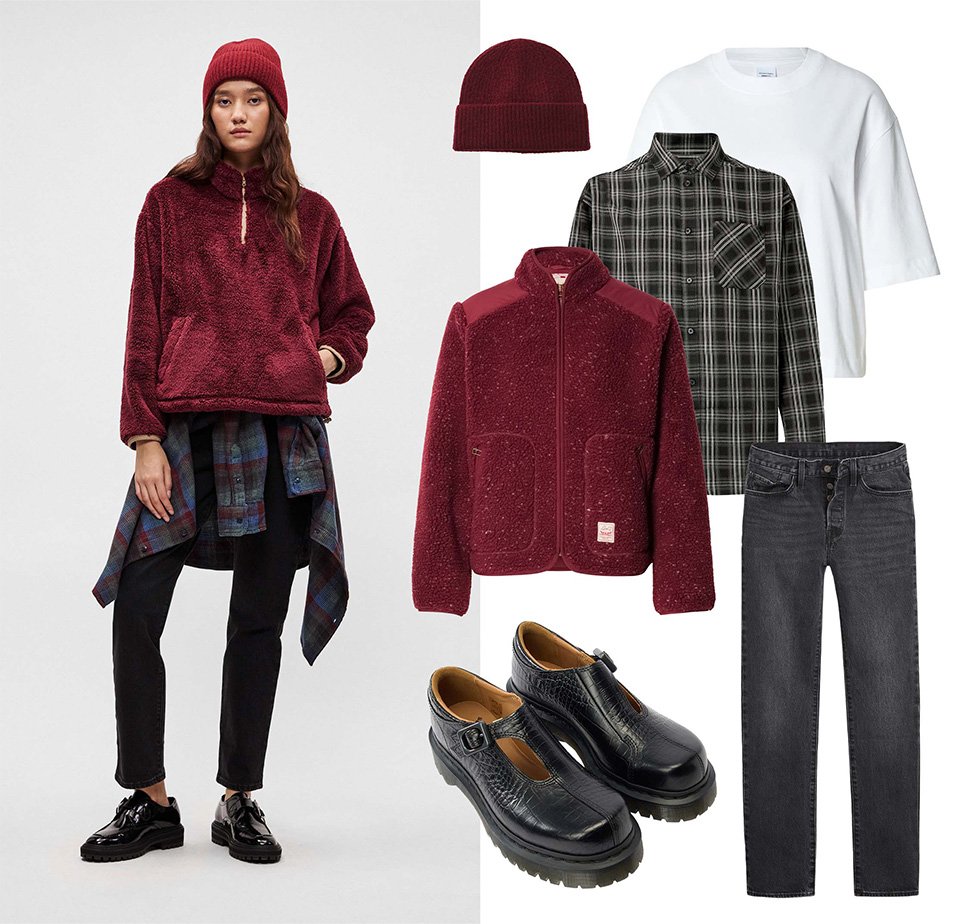 Pulover din fleece vișiniu, blugi negri, cămașă în carouri, tricou alb, cagulă vișinie și pantofi negri cu detalii de cataramă expuse împreună.