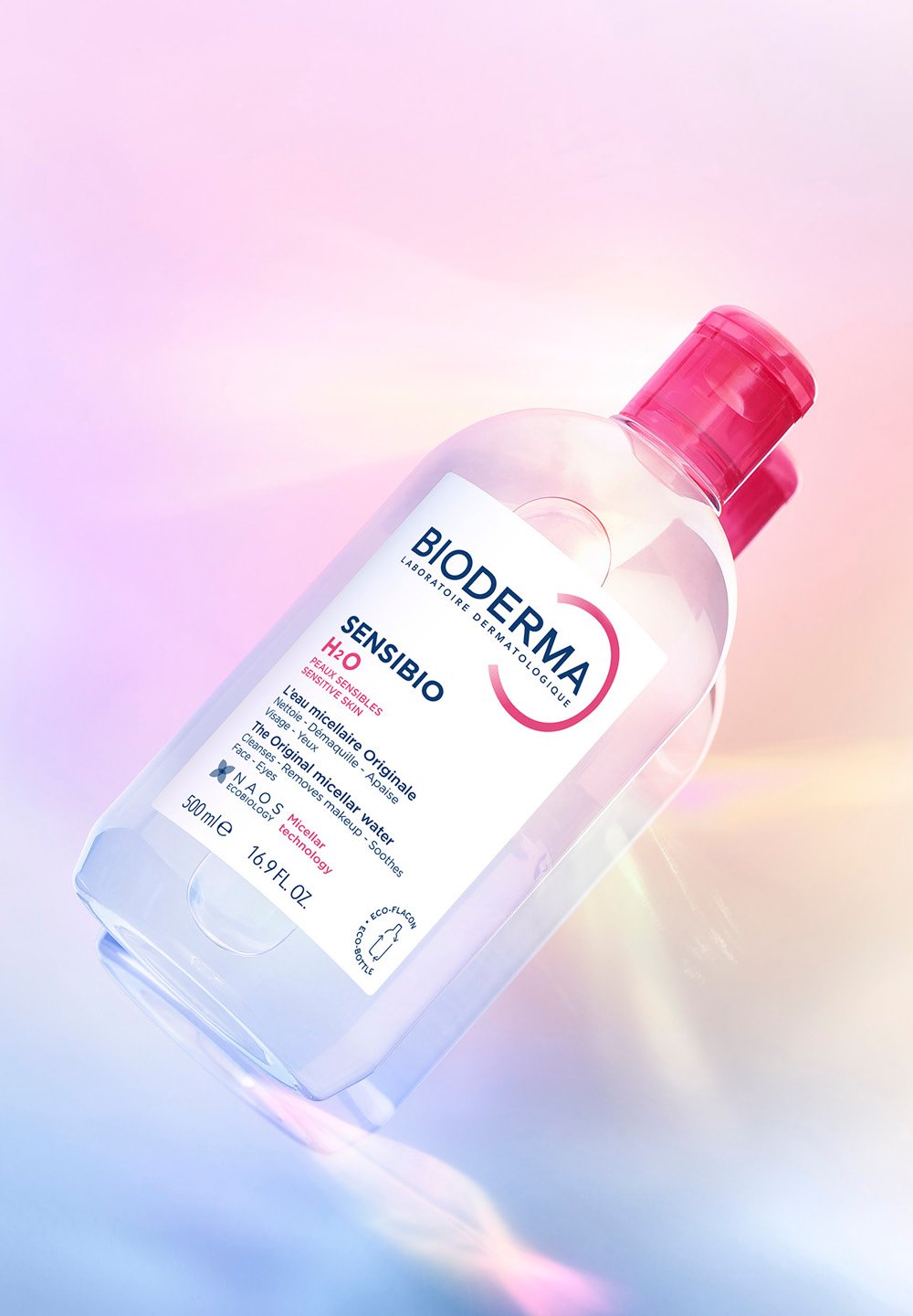 Transparent plastic bottle of Bioderma Sensibio H2O, features pink cap, 500ml capacity, and label with product information in clear print.