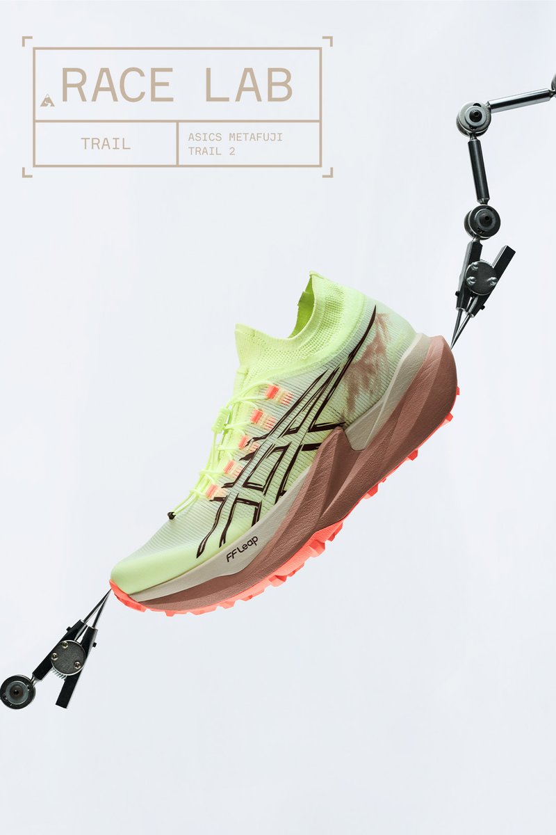 Light green Asics Metafuji Trail 2 running shoe held by mechanical arms with Race Lab text above on white background.