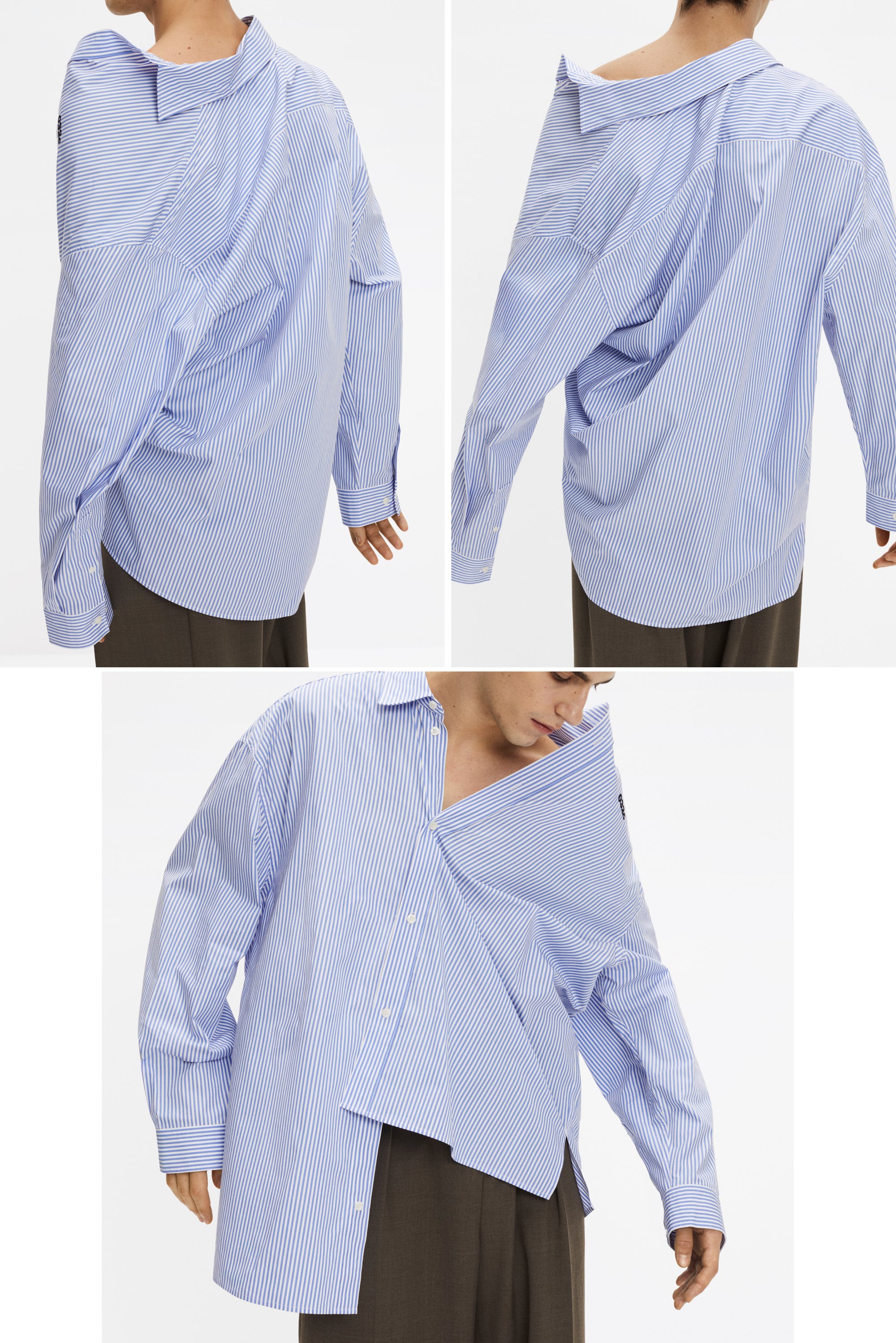 Una persona indossa una camicia a righe blu e bianche di taglia oversize, con una spalla scoperta e una chiusura asimmetrica con bottoni, abbinata a pantaloni marroni.