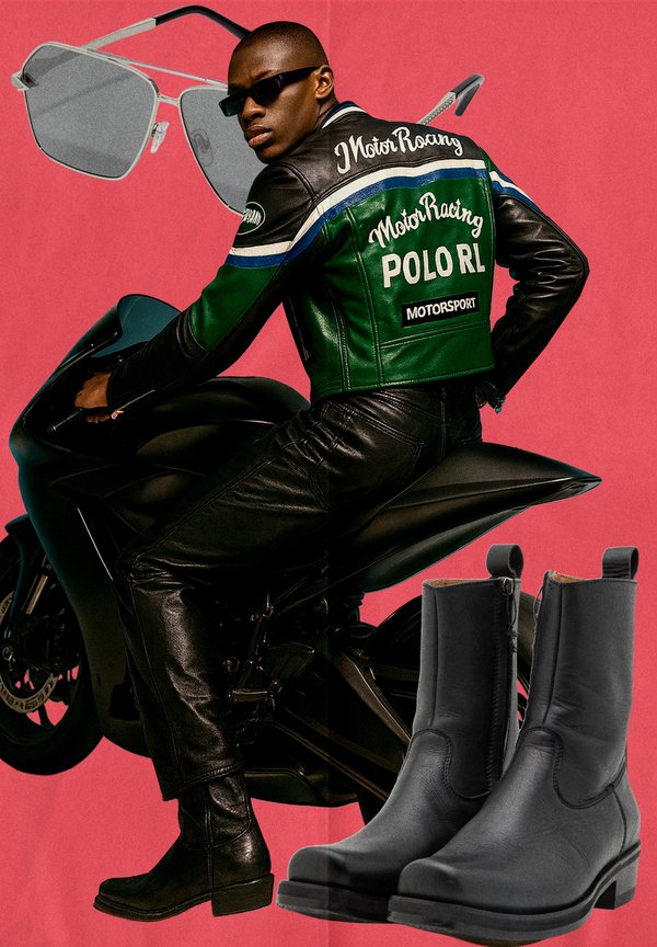 Black leather motorcycle jacket with green and blue accents, black leather trousers, black motorcycle boots, grey square sunglasses, and motorcycle.