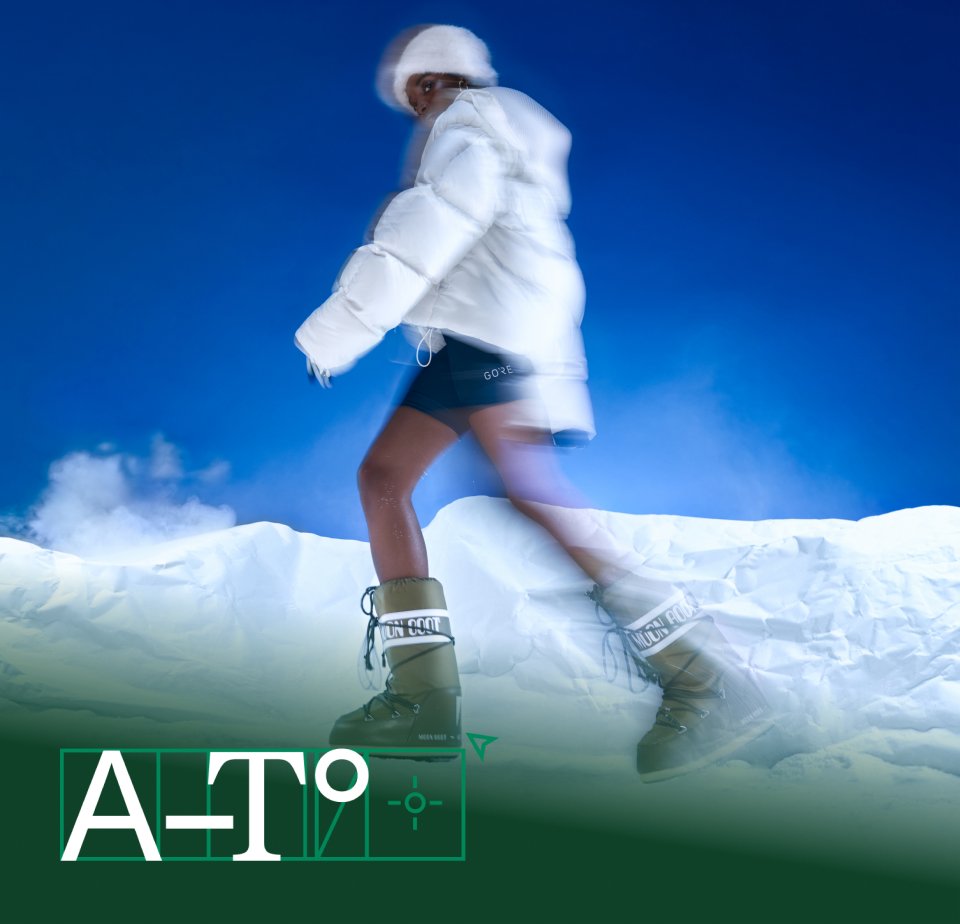 A person dressed in a white puffer jacket and boots strides across a snowy landscape against a bright blue sky, creating a dynamic effect.