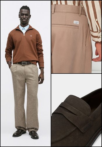 Barna cipzáras pulóver, világoskék galléros ing, bézs nadrág és sötétbarna mokaszin finom mintázattal.