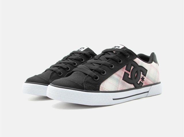 Low-top sneakers with black toe and laces, white soles, and pink plaid sides featuring a black DC logo on each shoe.