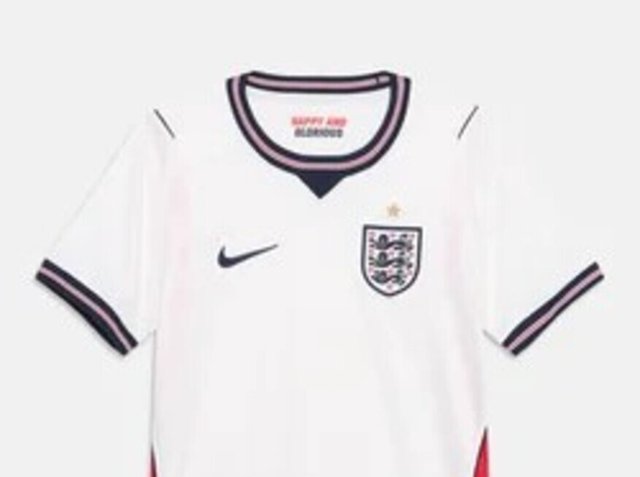 Fehér angol focimez fekete és rózsaszín díszítéssel, Nike logóval, Three Lions címerrel és egy arany csillaggal a címer felett.