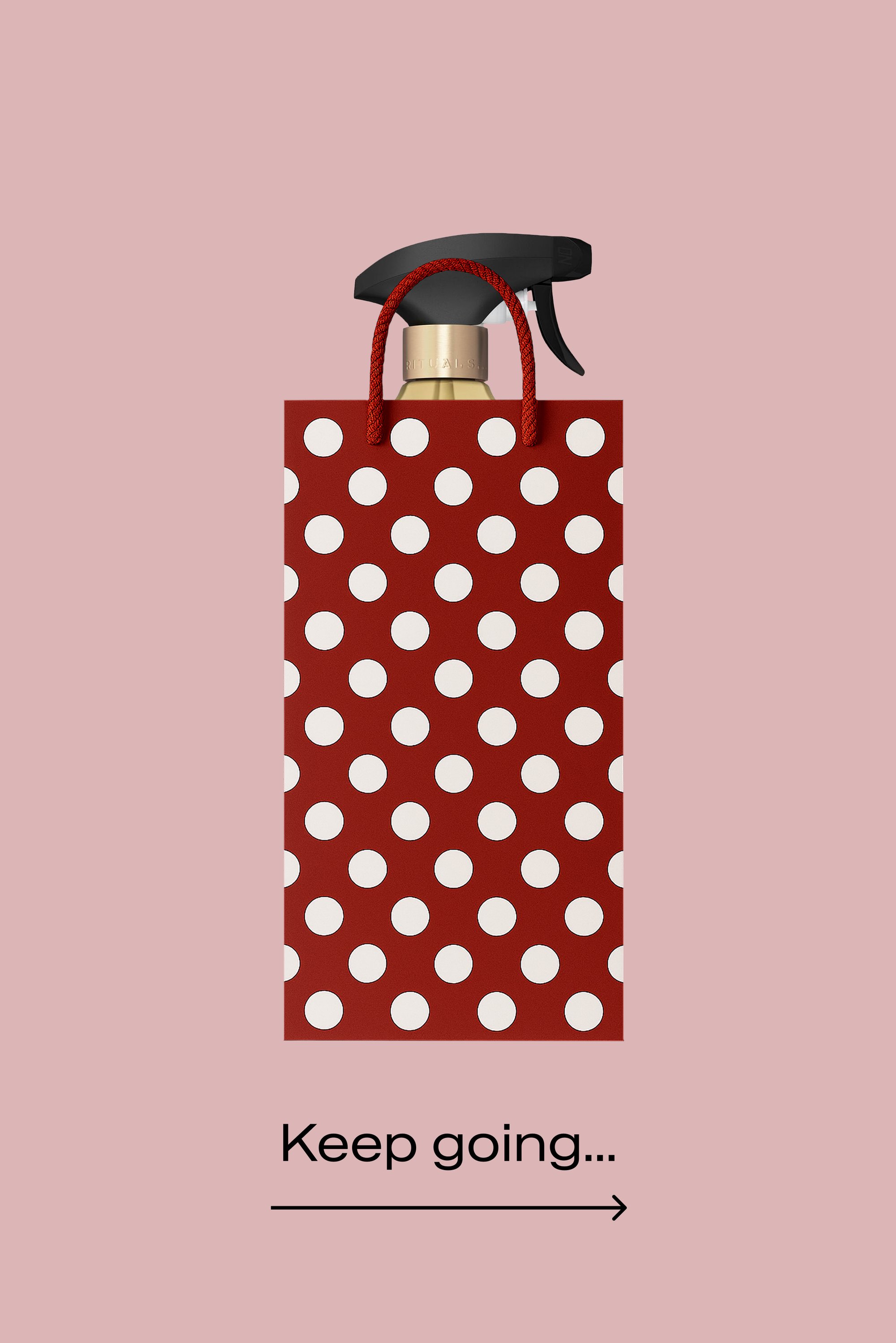 Borsa regalo rossa a pois con carta testurizzata, con un flacone spray nero e tappo con accento dorato, manici in corda rossa.