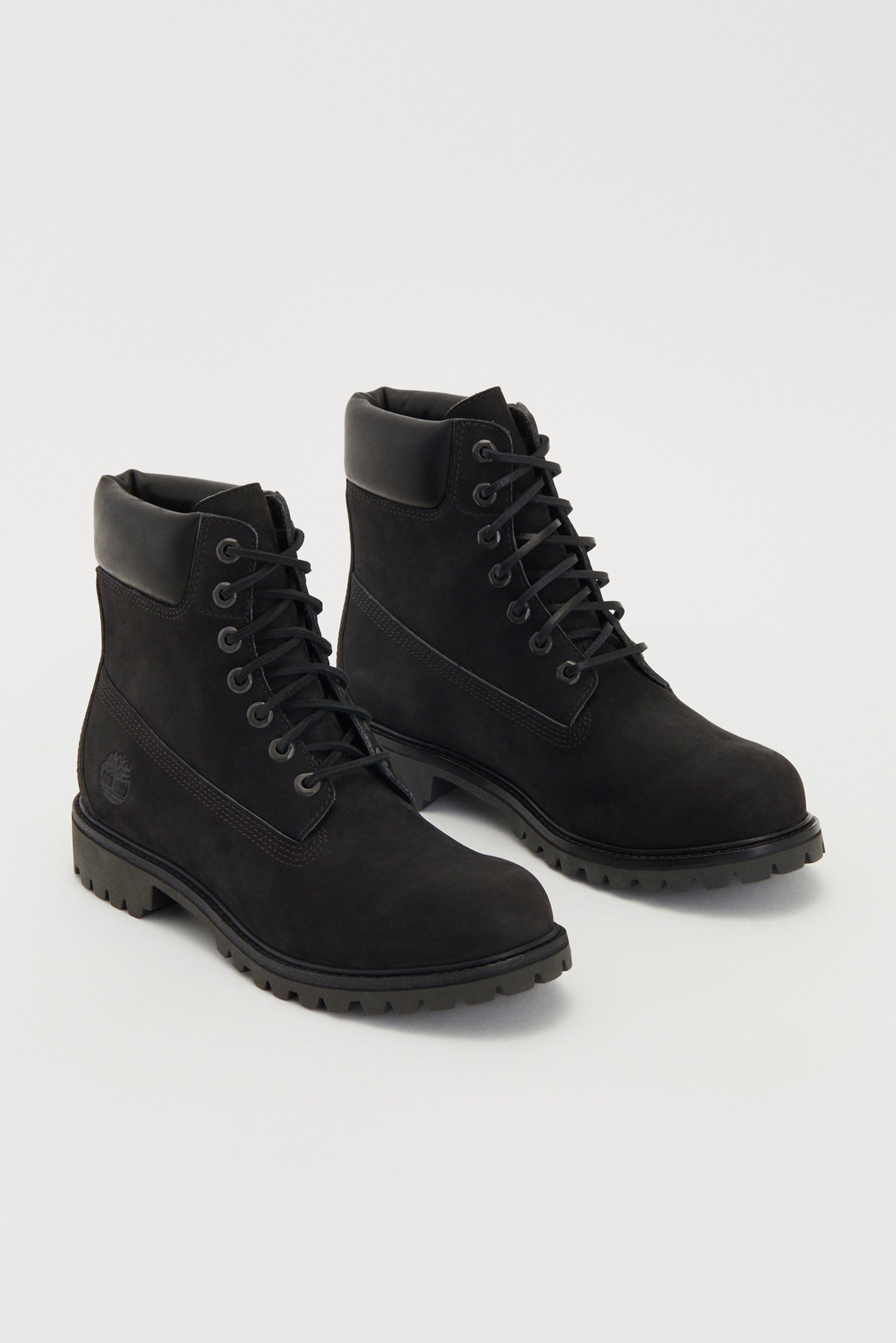 Black suede ankle boots with a round toe, lace-up front, padded collar, and a rugged outsole featuring a logo detail on the side.