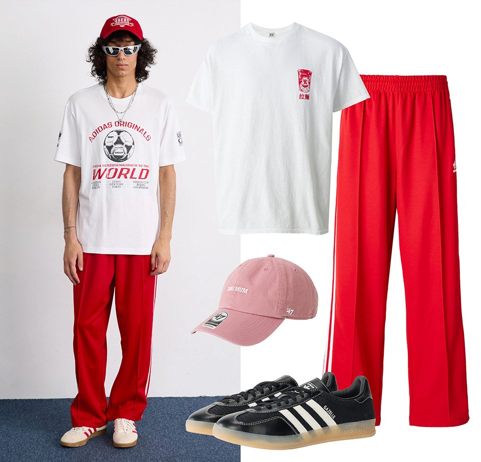 Adidas rode trainingsbroek, wit graphic t-shirt, roze pet en zwarte sneakers met rubberen zolen. De outfit heeft gedurfde kleuren en een casual stijl.