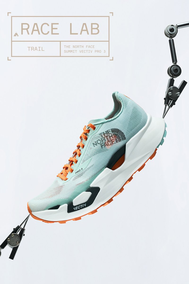 Light blue and orange trail running shoe suspended by mechanical arms with text "Race Lab Trail The North Face Summit Vectiv Pro 3."