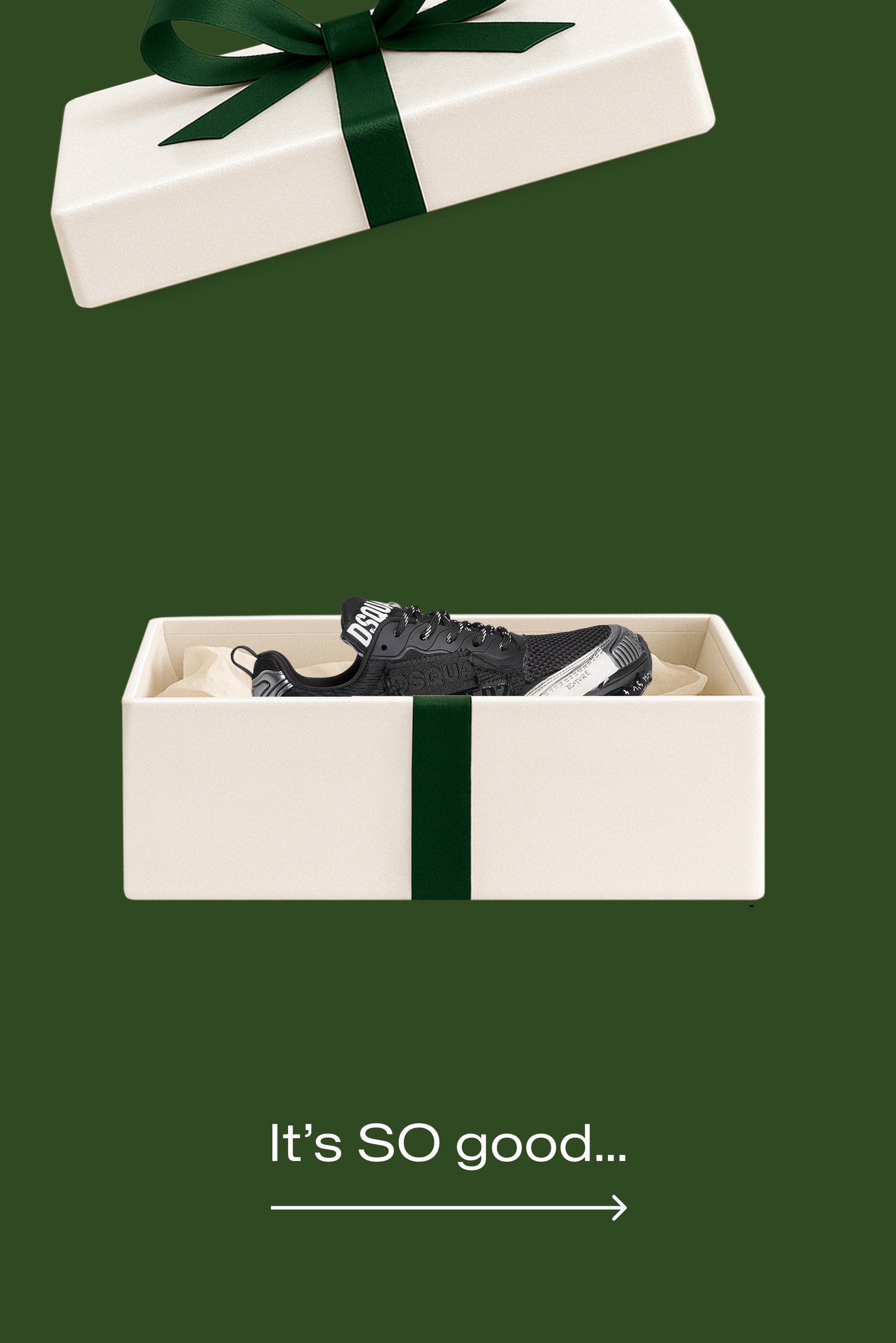 Caja de regalo blanca con una cinta verde oscuro, que contiene un zapato deportivo negro con tela texturizada y suela blanca a contraste. Papel picado en el interior.