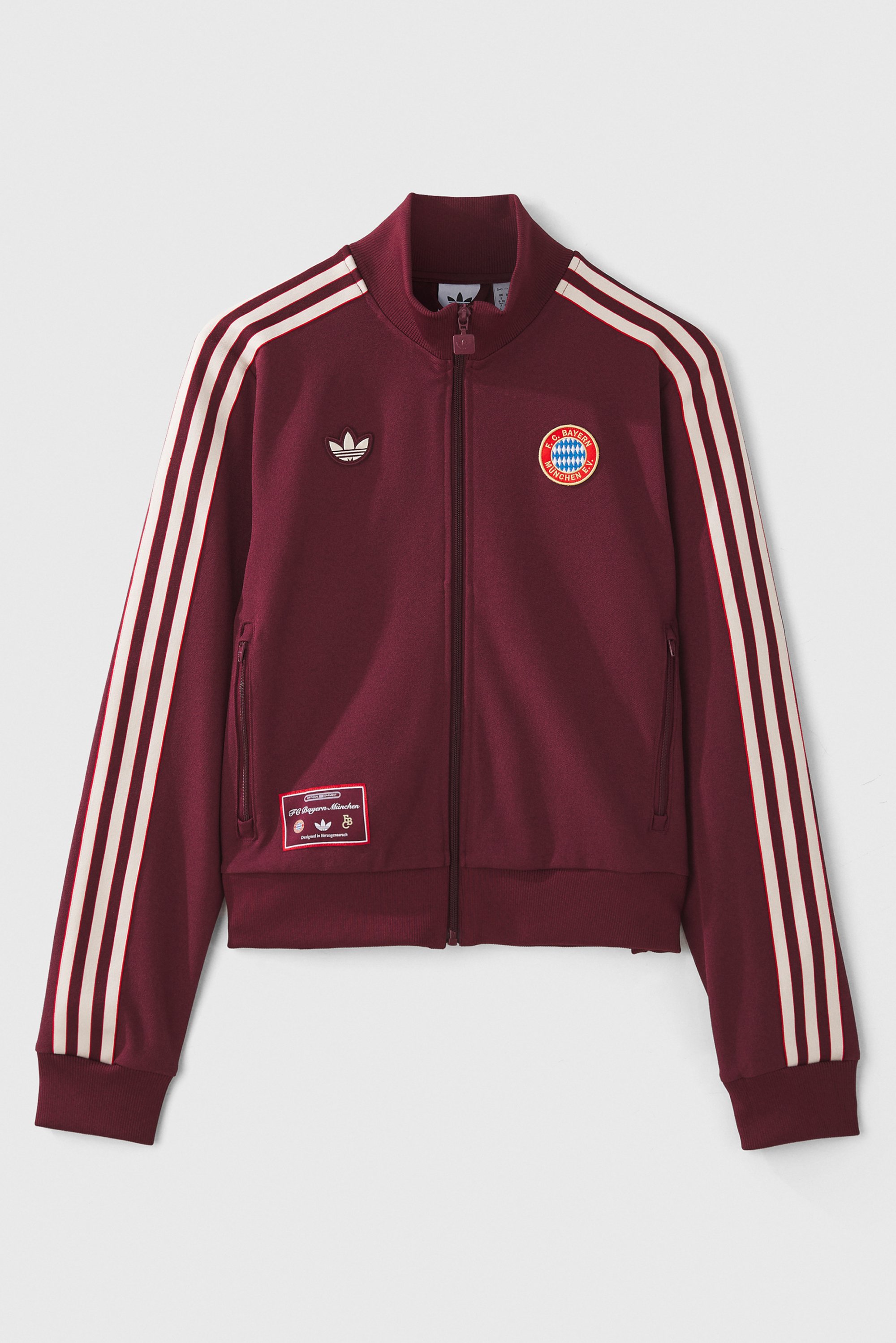 Maroon track jacket featuring white Adidas stripes, logo, and Bayern Munich emblem on the chest, with a zip front and side pockets.