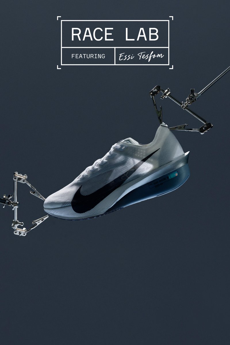 Nike racing shoe in white with black accents, featuring a streamlined design and textured surface. Supported by mechanical arms in a dark background.