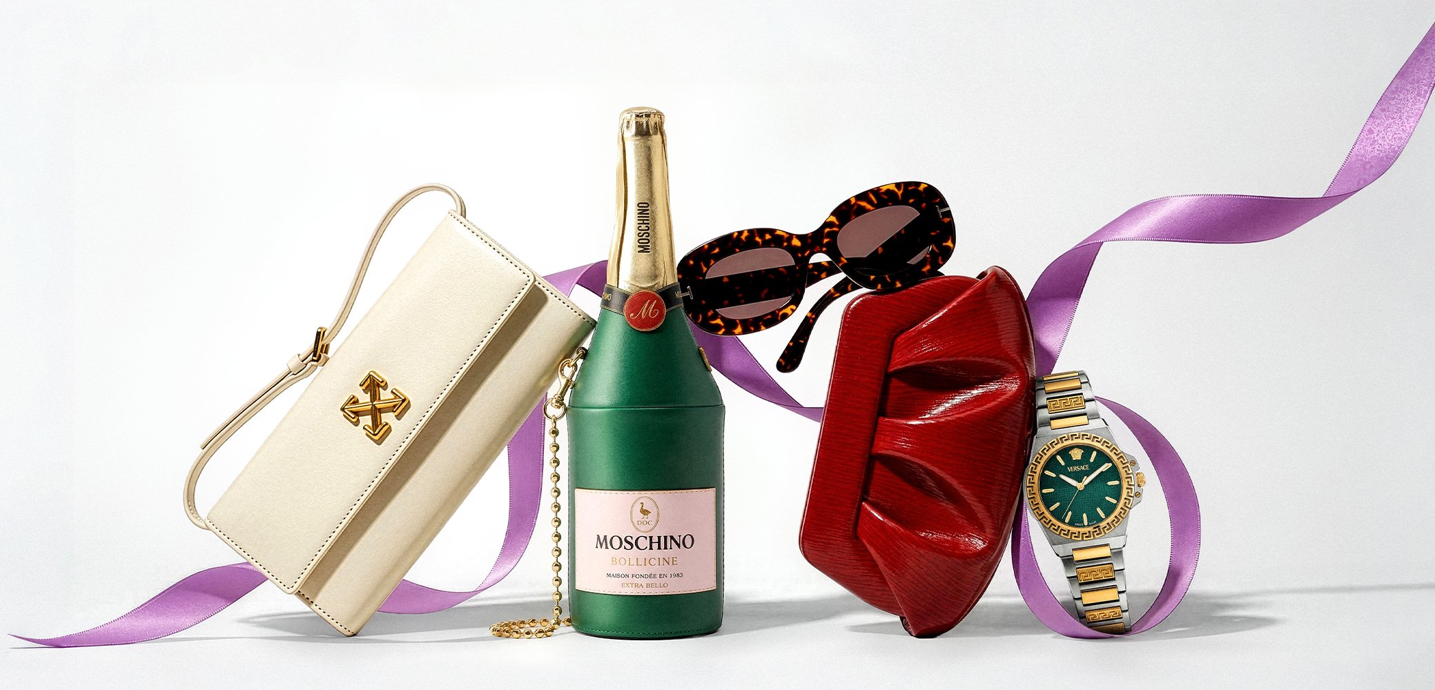 White designer purse, green bottle-shaped clutch, tortoiseshell sunglasses, red ruched clutch, gold and silver wristwatch with teal face, purple ribbon.