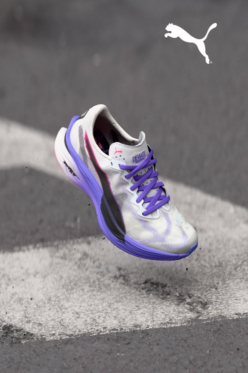 Puma running shoe with a white and purple design, featuring a textured upper, purple laces, and a distinctive black stripe along the side.