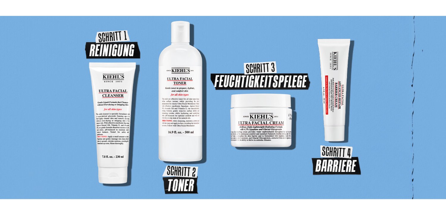 Vier Kiehl's Hautpflegeprodukte auf einem blauen Hintergrund: ein Reiniger, ein Toner, eine Creme und eine Reparaturcreme, alle mit unterschiedlichen Verpackungen und Etiketten.