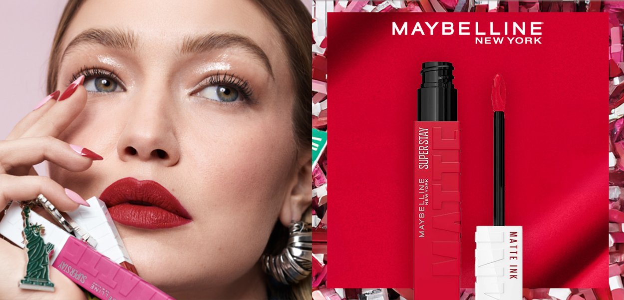 Maybelline Superstay Matte Ink liquid lipstick in a matte red tube, featuring a precision applicator, set against textured pink and red background.