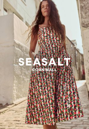 Floral-printed dress with a fitted bodice and flared skirt, featuring a mix of green, red, and blue colors on a light background.