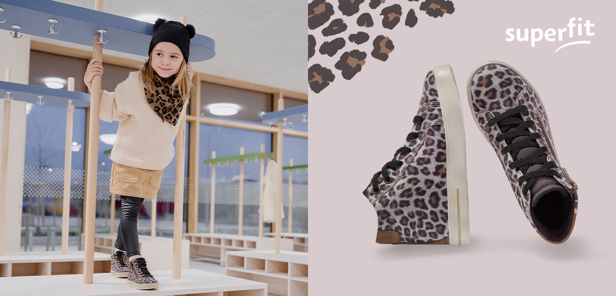 Kind, der Leopardenmuster-Sneaker und passendes Tuch trägt, steht drinnen; Seiten- und Oberansicht der Leopardenmuster-Sneaker mit schwarzen Schnürsenkeln.