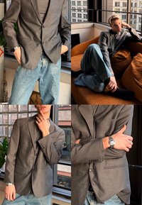 Νεαρός φορά γκρι σακάκι, μαύρο πουκάμισο, μπλε τζιν, ασημένιο ρολόι και δαχτυλίδια, ποζάρει σε εσωτερικό χώρο κοντά σε παράθυρα και σε καφέ καναπέ.