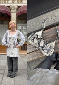 Grå oversized hettegenser og hvit kjole med blonder over grå vide bukser, kombinert med en svart-hvitt ormeskinnmønstret veske.