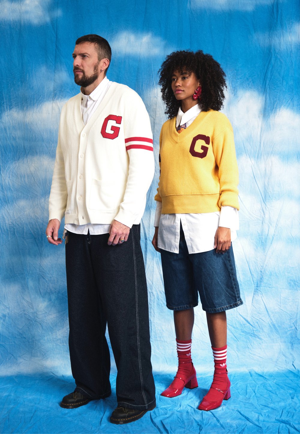 White cardigan with red accents and "G" logo, teamed with dark wide-leg trousers. Yellow jumper featuring "G" logo, denim shorts, and red shoes.