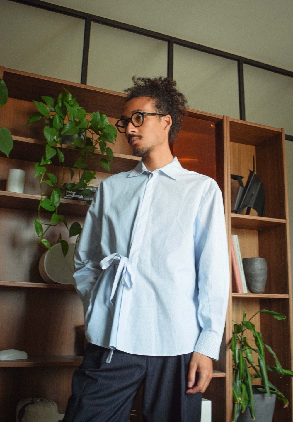 Lichtblauwe, knoopsluiting shirt met een strikdetail in de taille, lange mouwen en een klassieke kraag, gecombineerd met gestreepte broek.