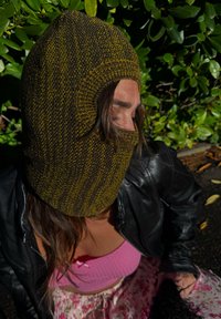 Knit balaclava with a textured pattern in dark brown and olive green. It features a full view opening for the eyes and mouth, made from soft material.