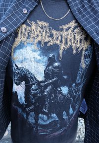 Black t-shirt showcasing a detailed graphic of a knight on horseback, with gold lettering above and a textured dark background.