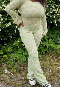 Πράσινο ριμπ λευκό σετ δύο τεμαχίων με μακριά μανίκια και φαρδύ παντελόνι, με υφή και λεπτομέρεια ιμάντα στο πλάι.