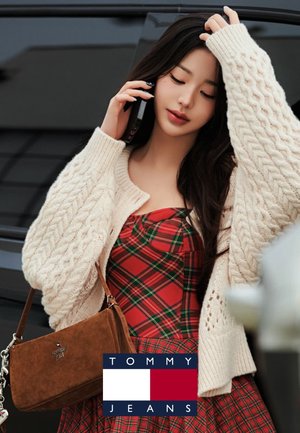 Cárdigan de punto en marfil, vestido de cuadros rojos y bolso de ante marrón. Modelo hablando por teléfono, con un fondo de un vehículo oscuro.