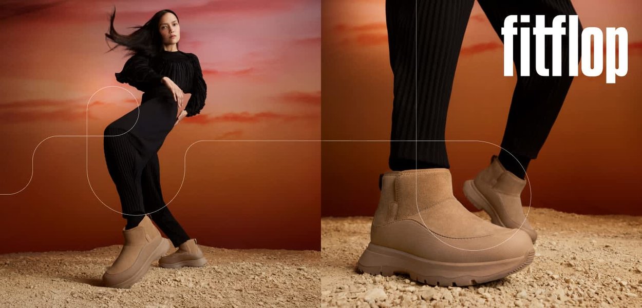 Beige ankle boots with a textured finish and cushioned soles. Rounded toe and elastic side panels; set against a warm, gradient background.
