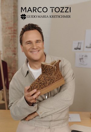 Leopard print ankle boot in brown suede with a textured finish, featuring a side zipper and a sturdy tan outsole.