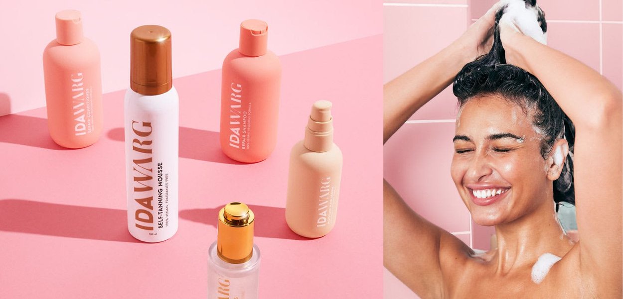 Cinque prodotti per capelli e abbronzatura IDA WARG con confezioni rosa e bianche, tra cui una mousse bianca, uno shampoo rosa e un siero trasparente, su uno sfondo rosa.