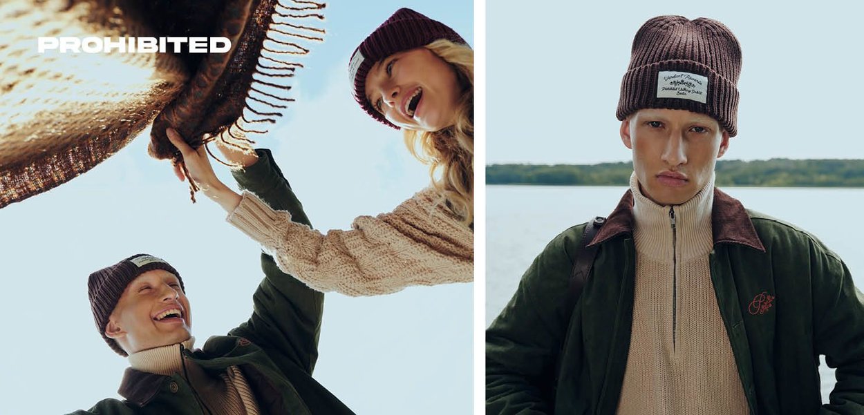 Braune Strickmütze mit einem Logopatch, kombiniert mit einem strukturierten beigen Pullover und einer dunkelgrünen Jacke mit Reißverschluss und braunen Akzenten.