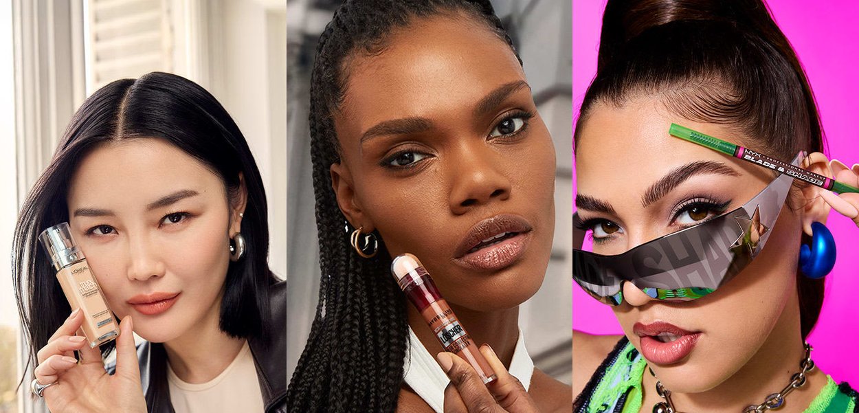 Tre kvinder viser skønhedsprodukter: en klar flaske med foundation, en multifarvet concealer og en grøn eyelinerblyant med solbriller.