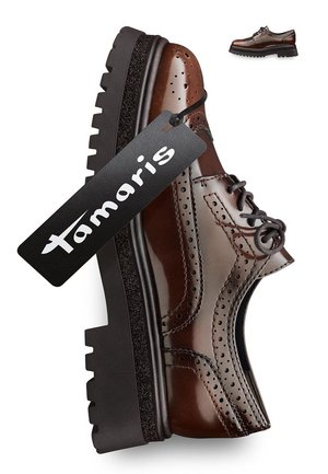 Brown leather shoe with brogue detailing, black textured sole, and a hang tag showing "Tamaris." Features classic lace-up design.