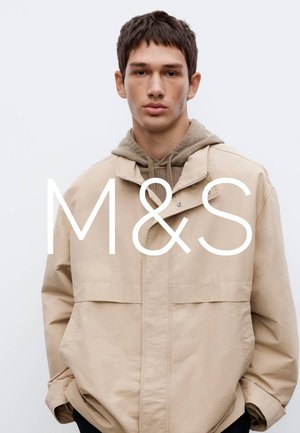 Beige, leichte Jacke mit zwei Vorder taschen und einem lockeren Schnitt. Wird über einem grauen Hoodie getragen, verfügt über einen Reißverschluss und eine weiche Textur.