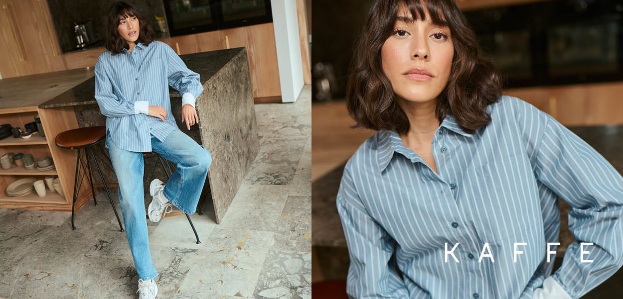 Light blue striped shirt made of soft fabric, featuring a button-up design and long sleeves. Paired with loose-fitting denim jeans.