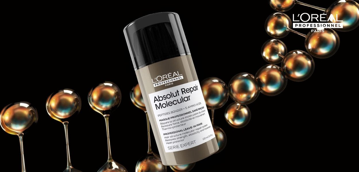 L'Oréal Professionnel Absolut Repair Molecular, a cylindrical bottle in beige and black, features a spray nozzle, with iridescent spheres in the background.