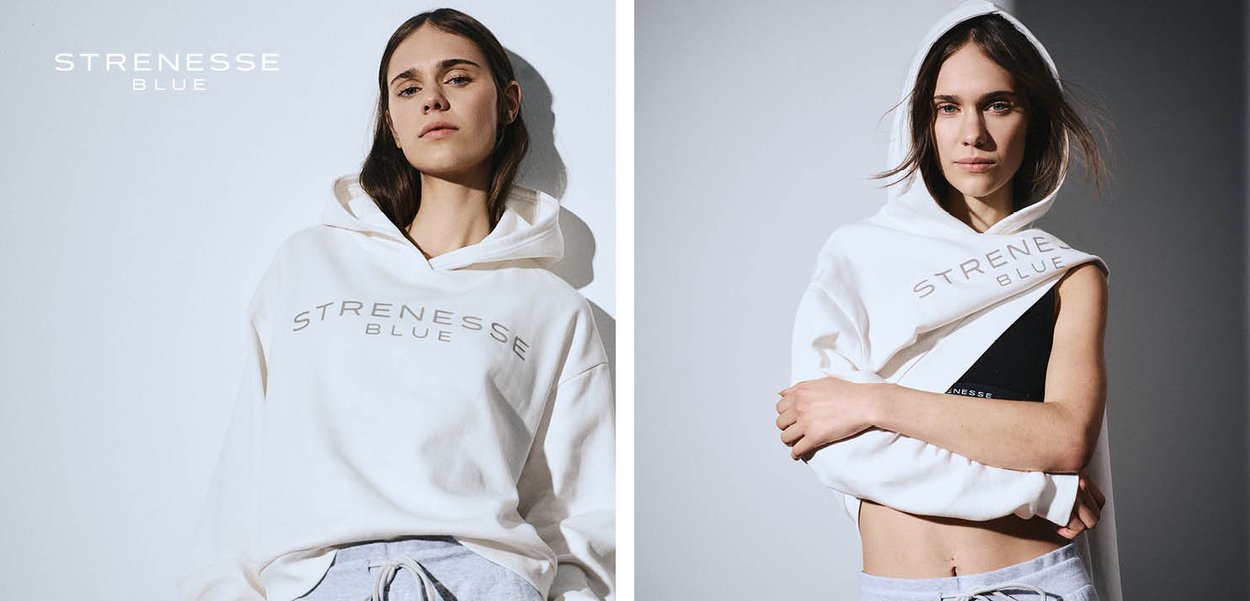 Frau trägt weißen Strenesse Blue Hoodie, auf zwei Arten gestylt, vor einfarbigem Hintergrund.