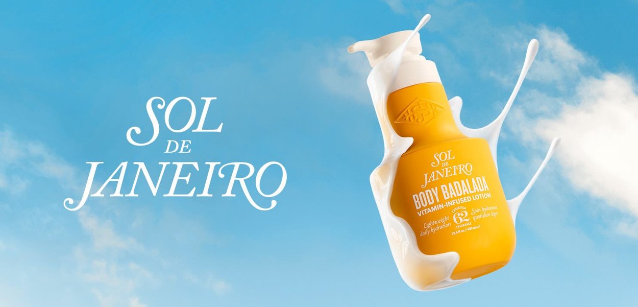 Yellow lotion bottle with a curved shape and textured accents, surrounded by splashes of white, against a blue sky background.