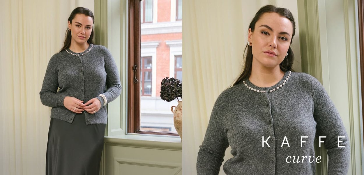 Grauer Wollcardigan mit rundem, verziertem Ausschnitt und Knopfverschluss, kombiniert mit einem langen, grauen Satinrock.