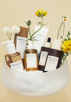 Set of six skincare products in various bottles; colors include brown, amber, and white. Features labels with "Centella" in bold.