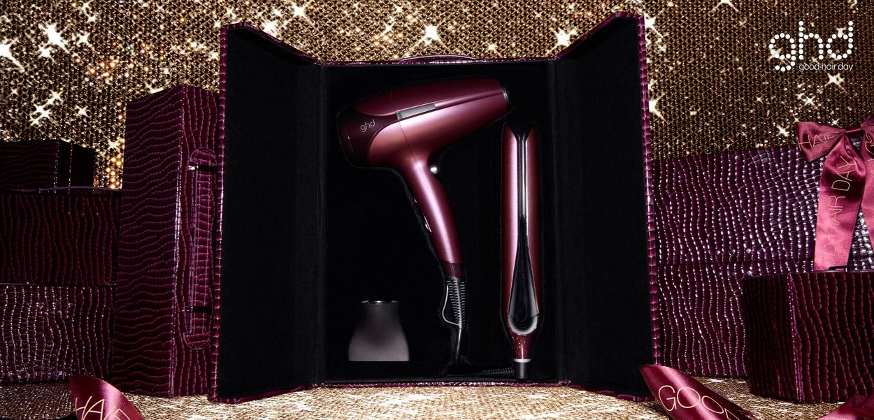 GHD hairdryer and straightener set in dark ruby casing with black interior. Features sleek, ergonomic design and glossy finish.