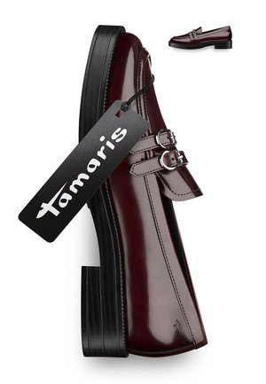 Burgundy patent leather loafer featuring double buckle straps, a flat black platform sole, and a tag labeled "Tamaris."