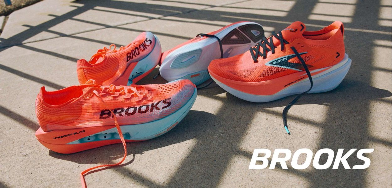 Bright orange Brooks running shoes with a mesh upper and contrasting blue sole. Features include laces and distinct branding on the side.