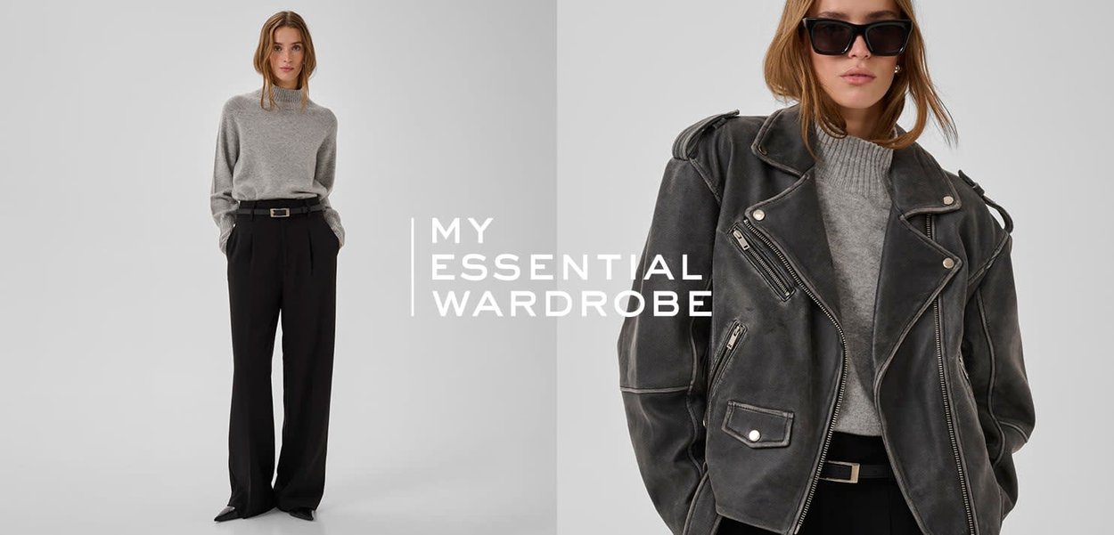 Grauer Strickpullover und schwarze maßgeschneiderte Hose kombiniert mit einer dunklen Leder-Motorradjacke. Das Model trägt übergroße schwarze Sonnenbrillen.