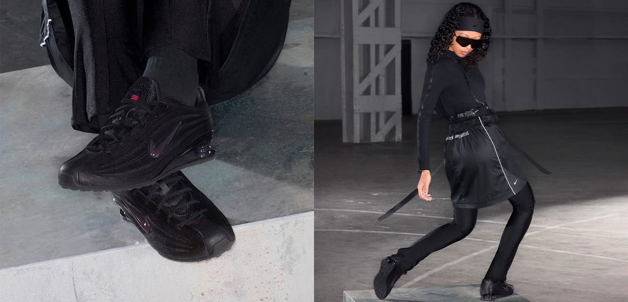 Una persona con un abbigliamento sportivo nero e occhiali da sole, che scende da una piattaforma, focalizzandosi sull'azione e sulle scarpe Nike nere.