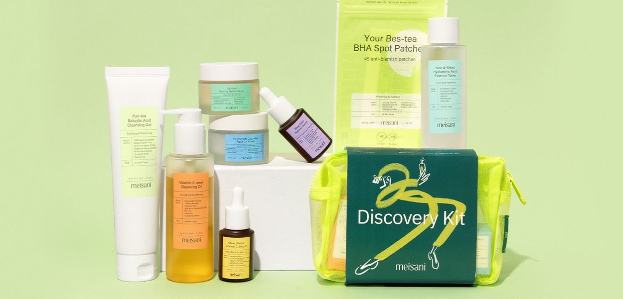 Eight skincare products arranged on a light green background, featuring various bottles and jars in shades of white, beige, and soft pastels.