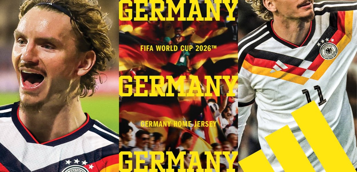 German soccer player in white home jersey with black, red, and yellow stripes celebrates, with fans and German flags in the background.